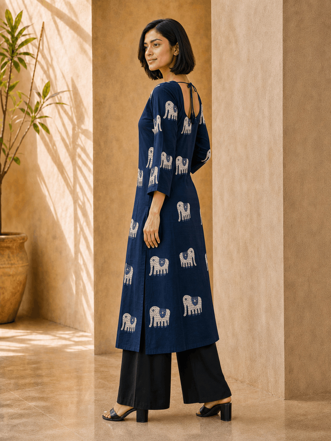 Side view of Neelam indigo Gajraj print long kurti showing flared sleeves and A-line fall